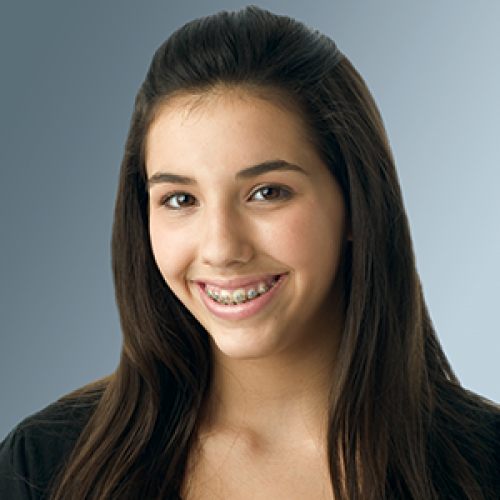 Picture of a teenage girl with dark hair wearing braces