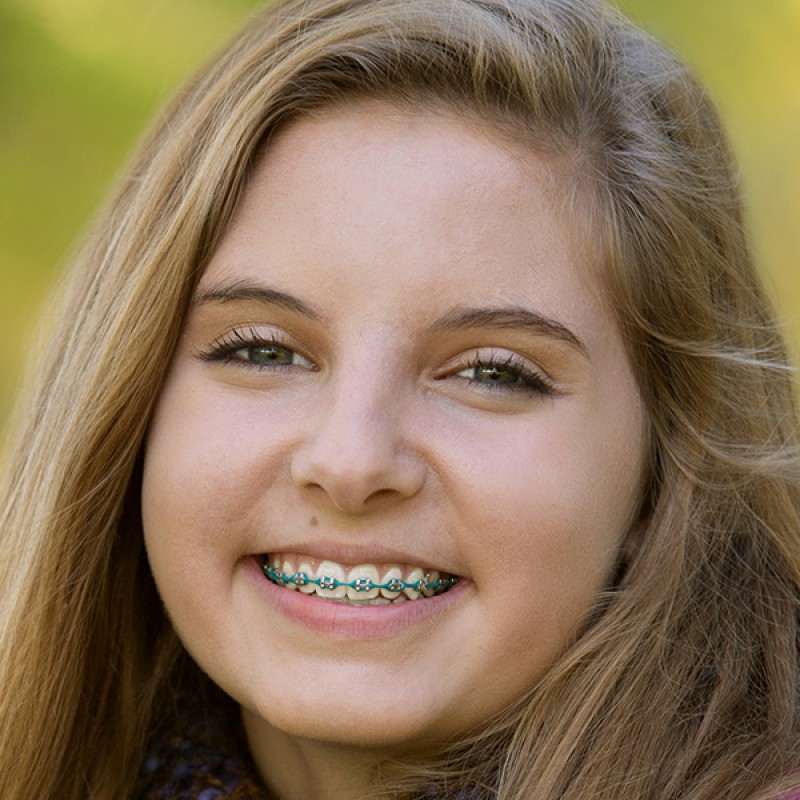 Picture of a young girl with braces and blonde hair