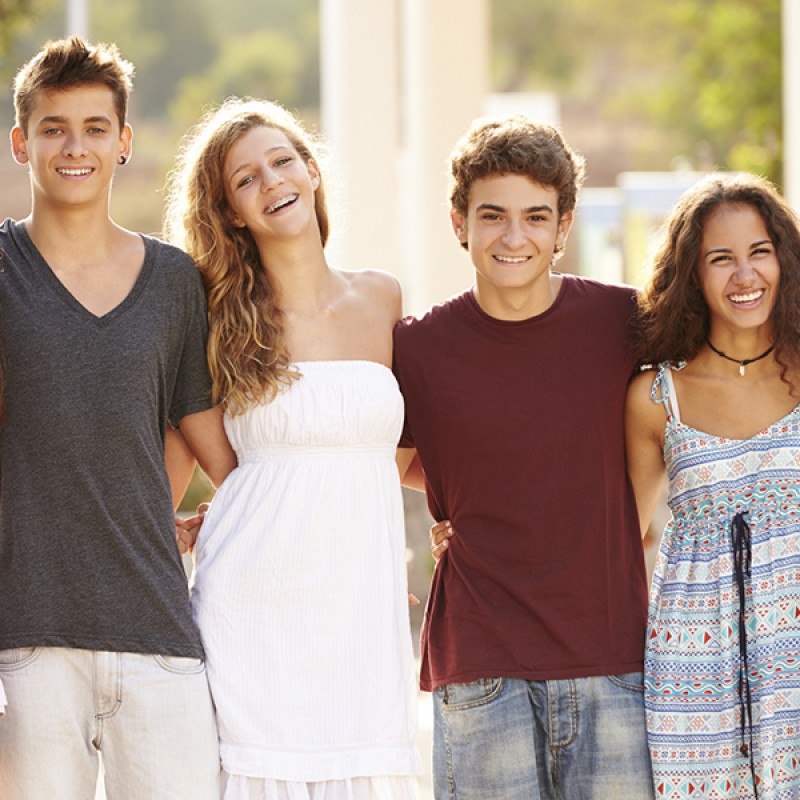 Picture of four teenagers, one of the girls is wearing braces